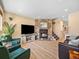Cozy living room with stone fireplace, wood flooring, and comfortable seating at 1247 S Idalia St, Aurora, CO 80017