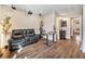 Bright living room featuring laminate flooring, an entertainment system, and a comfortable leather sofa at 1247 S Idalia St, Aurora, CO 80017