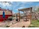 Serene backyard featuring a charming pergola with a fire pit and brick-paved patio for outdoor relaxation at 124 E Colorado Ave # 2, Denver, CO 80210