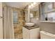 Cozy bathroom featuring a tiled shower with glass block window and a modern vessel sink at 124 E Colorado Ave # 2, Denver, CO 80210