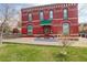 Charming two-story brick building with a well-maintained lawn and inviting entrance at 124 E Colorado Ave # 2, Denver, CO 80210
