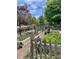 Fenced garden featuring raised garden beds, a variety of plants, and a rustic wooden fence at 124 E Colorado Ave # 2, Denver, CO 80210