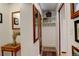 Hallway featuring a mirrored wall, a small antique table, and a charming storage nook at 124 E Colorado Ave # 2, Denver, CO 80210
