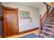 Inviting entryway features a wooden door, staircase, and a colorful piece of art at 124 E Colorado Ave # 2, Denver, CO 80210