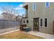 Property with fenced backyard, exterior of the house, and a patio dining set at 4544 Utica St, Denver, CO 80212