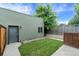 Backyard with fresh grass, a private fence, and cozy string lights, perfect for relaxing outdoors at 4544 Utica St, Denver, CO 80212