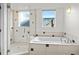 Bright bathroom features include a soaking tub, glass-enclosed shower, and modern tile accents at 4544 Utica St, Denver, CO 80212