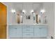 Bright bathroom featuring a blue double vanity with sleek mirrors and contemporary lighting fixtures at 4544 Utica St, Denver, CO 80212