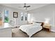 Bright primary bedroom features neutral colors, a ceiling fan, and a dresser with drawers at 4544 Utica St, Denver, CO 80212