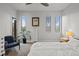 Comfortable bedroom featuring neutral colors, three windows, and a ceiling fan at 4544 Utica St, Denver, CO 80212
