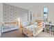 Bright bedroom with playful wallpaper, comfortable beds, and plenty of natural light at 4544 Utica St, Denver, CO 80212