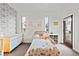 Stylized bedroom with a playful wallpaper accent wall, complemented by colorful artwork at 4544 Utica St, Denver, CO 80212