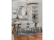 Bright dining area featuring a stylish light fixture, hardwood floors, and open layout to the modern kitchen at 4544 Utica St, Denver, CO 80212