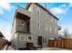 Back of property with a patio dining set, small balcony, and exterior lighting at 4544 Utica St, Denver, CO 80212