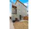 Back exterior of a modern home with a patio and fenced yard at 4544 Utica St, Denver, CO 80212