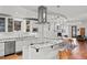 Open-concept kitchen with a breakfast bar, stainless steel appliances, and seamless flow into the dining and living areas at 4544 Utica St, Denver, CO 80212