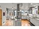 Stylish kitchen featuring granite countertops, stainless steel appliances, island seating, and hardwood floors at 4544 Utica St, Denver, CO 80212