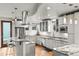 Modern kitchen with granite countertops, stainless steel appliances, ample counter space, and hardwood floors at 4544 Utica St, Denver, CO 80212