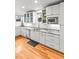 Spacious kitchen features stainless steel appliances and granite countertops with wood floors at 4544 Utica St, Denver, CO 80212