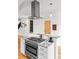 Kitchen features a professional range with granite countertops and stainless steel vent hood at 4544 Utica St, Denver, CO 80212