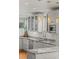 Bright kitchen with granite countertops, white cabinets, stainless steel appliances and stylish subway tile backsplash at 4544 Utica St, Denver, CO 80212