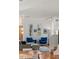 Bright living area featuring wood floors, blue armchairs, and natural light from the windows at 4544 Utica St, Denver, CO 80212