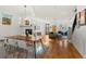 Open living room with dining area, fireplace, wood floors, and stairs at 4544 Utica St, Denver, CO 80212