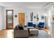 Bright living area featuring wood floors, stylish furniture, and natural light from windows at 4544 Utica St, Denver, CO 80212