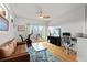 Bright living room with hardwood floors, balcony access, and a comfortable seating and work area at 4544 Utica St, Denver, CO 80212