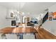 Open living room with dining area, fireplace, wood floors, stairs, and modern decor at 4544 Utica St, Denver, CO 80212
