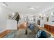 Open-concept living area with hardwood floors, fireplace, and modern kitchen and dining area at 4544 Utica St, Denver, CO 80212