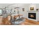 Open living space with fireplace, adjacent dining area, and modern kitchen for seamless entertaining at 4544 Utica St, Denver, CO 80212