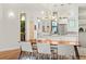 Open floor plan with kitchen, dining area with modern chandelier, and access to hall at 4544 Utica St, Denver, CO 80212