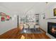 Open floor plan with dining area, modern chandelier, fireplace, and wood floors at 4544 Utica St, Denver, CO 80212