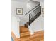 Staircase with modern railing and treads transitioning to hardwood floors on lower level at 4544 Utica St, Denver, CO 80212