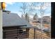 Balcony view showcases the surrounding neighborhood, mature trees, and clear blue sky at 4544 Utica St, Denver, CO 80212
