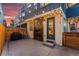 Private backyard patio featuring a modern gas fireplace and string lights, perfect for outdoor gatherings at 1259 Perry St, Denver, CO 80204