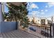 A beautiful wooden balcony offers unobstructed views of the neighborhood's modern architecture and serene street at 1259 Perry St, Denver, CO 80204