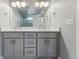 Bathroom featuring double vanity with granite countertop, and modern lighting at 1259 Perry St, Denver, CO 80204