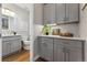 Bathroom with gray cabinets, white countertop, stylish light fixture, and modern decor at 1259 Perry St, Denver, CO 80204