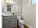 Bathroom featuring gray vanity, silver faucet, and updated light fixture at 1259 Perry St, Denver, CO 80204