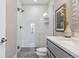 Modern bathroom featuring a glass-enclosed shower, white subway tile, and modern vanity with a marble countertop at 1259 Perry St, Denver, CO 80204