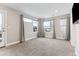 Bright bedroom with carpet floors, several windows with a door to the outside balcony at 1259 Perry St, Denver, CO 80204