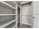 Walk-in closet featuring built-in shelving and hanging rods for organized storage at 1259 Perry St, Denver, CO 80204