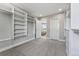 Spacious walk-in closet with gray carpet, custom shelving, and an entrance to a bedroom with neutral decor at 1259 Perry St, Denver, CO 80204
