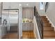 Kitchen featuring a stainless steel refrigerator, gray cabinets, and stairs to the second level at 1259 Perry St, Denver, CO 80204
