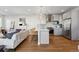 Open kitchen and living room layout with island seating, stainless steel appliances, and modern finishes at 1259 Perry St, Denver, CO 80204