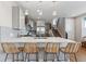 Contemporary kitchen features stainless steel appliances, a large island with bar seating, and a modern staircase at 1259 Perry St, Denver, CO 80204