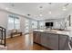 Open concept living area flows from kitchen featuring ample sunlight and hardwood floors at 1259 Perry St, Denver, CO 80204