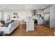 Open-concept space with kitchen island and seating flowing into a cozy living room with hardwood floors and modern decor at 1259 Perry St, Denver, CO 80204